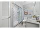 Updated bathroom with a glass-enclosed shower, granite countertop, and decorative wall art at 2020 Port Royal Rd, Raleigh, NC 27609