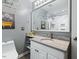 Bathroom featuring a granite countertop vanity, decorative wall art, and framed mirror at 2020 Port Royal Rd, Raleigh, NC 27609