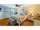 Cozy bedroom with a detailed bed frame, complementary furniture, and a ceiling fan, designed for comfort and relaxation at 2020 Port Royal Rd, Raleigh, NC 27609