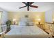 Sunlit bedroom with hardwood floors, a ceiling fan, and a neutral color scheme at 2020 Port Royal Rd, Raleigh, NC 27609