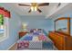 Cozy bedroom with a brightly patterned quilt and light blue walls at 2020 Port Royal Rd, Raleigh, NC 27609
