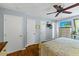Bright bedroom featuring three closets, hardwood floors, and a ceiling fan at 2020 Port Royal Rd, Raleigh, NC 27609