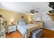 Comfortable bedroom featuring a ceiling fan, ensuite bathroom, and plenty of natural light at 2020 Port Royal Rd, Raleigh, NC 27609