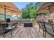 Spacious wooden deck with outdoor seating and umbrellas, perfect for entertaining guests and relaxing outdoors at 2020 Port Royal Rd, Raleigh, NC 27609