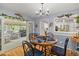 Cozy dining area with light blue walls, wood floors, and an adjacent seating area, providing an open and inviting space at 2020 Port Royal Rd, Raleigh, NC 27609