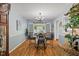Bright dining area with a round table, leading to a sunroom through glass doors, enhancing the natural light and openness at 2020 Port Royal Rd, Raleigh, NC 27609
