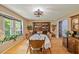 Elegant dining room with hardwood floors, a large window, and classic wooden furniture at 2020 Port Royal Rd, Raleigh, NC 27609
