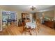 Dining room featuring hardwood floors, a table with chairs, and adjacent living spaces at 2020 Port Royal Rd, Raleigh, NC 27609