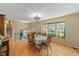 Traditional dining room with hardwood floors, a large window with natural light, and a wooden table at 2020 Port Royal Rd, Raleigh, NC 27609