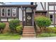 Inviting entrance with brick steps, a decorative wreath on the front door, and manicured bushes at 2020 Port Royal Rd, Raleigh, NC 27609