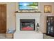 Close-up of a white brick fireplace with an electric firebox, custom mantle, and hearth at 2020 Port Royal Rd, Raleigh, NC 27609