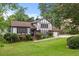 Charming Tudor-style home with manicured lawn, mature trees, brick accents, and a welcoming entrance at 2020 Port Royal Rd, Raleigh, NC 27609