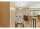 Hallway with a decorative wreath, access to the rooms and a railing with plants at 2020 Port Royal Rd, Raleigh, NC 27609
