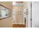 Bright hallway with artwork and access to various rooms, highlighting the home's layout and charming interior design at 2020 Port Royal Rd, Raleigh, NC 27609