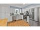 Spacious kitchen featuring stainless steel appliances, white cabinetry, and hardwood flooring at 2020 Port Royal Rd, Raleigh, NC 27609
