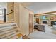 Carpeted staircase leading to the living room featuring a fireplace and neutral-toned furniture at 2020 Port Royal Rd, Raleigh, NC 27609