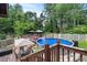 Backyard features an above-ground pool with a deck and outdoor seating, perfect for enjoying summer days at 2020 Port Royal Rd, Raleigh, NC 27609