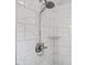 Detailed view of a modern shower with white marble tile and updated fixture at 2020 Port Royal Rd, Raleigh, NC 27609