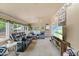 Inviting sunroom with large windows, comfortable furniture, and a ceiling fan, perfect for relaxation and enjoying natural light at 2020 Port Royal Rd, Raleigh, NC 27609