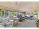 Bright sunroom with multiple windows, comfortable seating, and ceiling fans, creating a relaxing and inviting atmosphere at 2020 Port Royal Rd, Raleigh, NC 27609