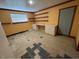 Basement workspace with shelves, cabinets, a window, and vinyl floors at 2022 Bivins St, Durham, NC 27707