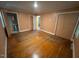 Bedroom showcases hardwood floors, neutral walls, standard closet, and bathroom at 2022 Bivins St, Durham, NC 27707