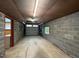 Spacious garage with concrete floors, cinder block walls, and garage door at 2022 Bivins St, Durham, NC 27707