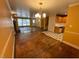 Open-concept living room with hardwood floors, stone fireplace, and adjoining kitchen area at 2022 Bivins St, Durham, NC 27707