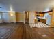 Open-concept living area with hardwood floors, a nearby staircase, and an adjacent kitchen at 2022 Bivins St, Durham, NC 27707