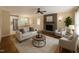 Staged living room featuring modern furniture, a stone fireplace, and an open-concept design at 2022 Bivins St, Durham, NC 27707