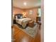 Cozy bedroom featuring hardwood floors, a decorative rug, and neutral paint at 2022 Bivins St, Durham, NC 27707