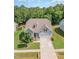 Beautiful aerial view of a home with a well-manicured lawn, mature trees, and a welcoming facade at 210 Olde Liberty Dr, Youngsville, NC 27596