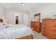 Cozy bedroom features a light wooden dresser and a glimpse into an organized walk-in closet at 210 Olde Liberty Dr, Youngsville, NC 27596