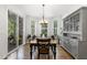 Bright dining room with a large table, bay window, and a stylish china cabinet at 210 Olde Liberty Dr, Youngsville, NC 27596