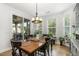 Elegant dining room with a wooden table, views of the outdoor patio, and ample natural light at 210 Olde Liberty Dr, Youngsville, NC 27596