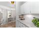 Bright kitchen with white cabinets, granite counters, and open view to dining area at 210 Olde Liberty Dr, Youngsville, NC 27596