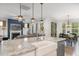 Open kitchen with granite counters, stainless appliances, and views into the living room and dining area at 210 Olde Liberty Dr, Youngsville, NC 27596