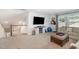 Open loft area with comfortable seating, large screen television, and staircase at 210 Olde Liberty Dr, Youngsville, NC 27596