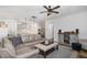 Open-concept living room with a view into the kitchen, hardwood floors, and stylish furnishings at 210 Olde Liberty Dr, Youngsville, NC 27596