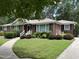 Lovely brick home with meticulous landscaping, complemented by a curved walkway and charming front porch at 211 Hillcrest Dr, Oxford, NC 27565