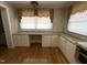 Kitchen with window desk area, granite counters, white cabinets and drawers and hardwood flooring at 211 Hillcrest Dr, Oxford, NC 27565