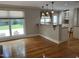 Open floorplan view featuring the kitchen and living room areas with hardwood floors and natural light at 211 Hillcrest Dr, Oxford, NC 27565