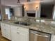 Open concept kitchen with granite countertops, stainless steel appliances and view of the fireplace at 211 Hillcrest Dr, Oxford, NC 27565