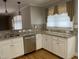 Bright kitchen with granite countertops, stainless steel appliances, and natural light from the window at 211 Hillcrest Dr, Oxford, NC 27565
