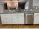 Renovated kitchen features stainless steel appliances, granite countertops, and decorative tile backsplash at 211 Hillcrest Dr, Oxford, NC 27565