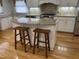 Spacious kitchen with an island, granite countertops, stainless steel appliances, and hardwood floors at 211 Hillcrest Dr, Oxford, NC 27565