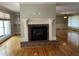 Bright and airy living room featuring a charming fireplace and gleaming hardwood floors at 211 Hillcrest Dr, Oxford, NC 27565