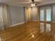 Bright living room featuring hardwood floors, neutral walls, and a ceiling fan at 211 Hillcrest Dr, Oxford, NC 27565