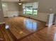 Bright living room boasting natural light, elegant wainscoting, and beautiful hardwood floors at 211 Hillcrest Dr, Oxford, NC 27565