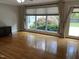 Spacious living area with large windows overlooking the landscaped yard and hardwood floors at 211 Hillcrest Dr, Oxford, NC 27565